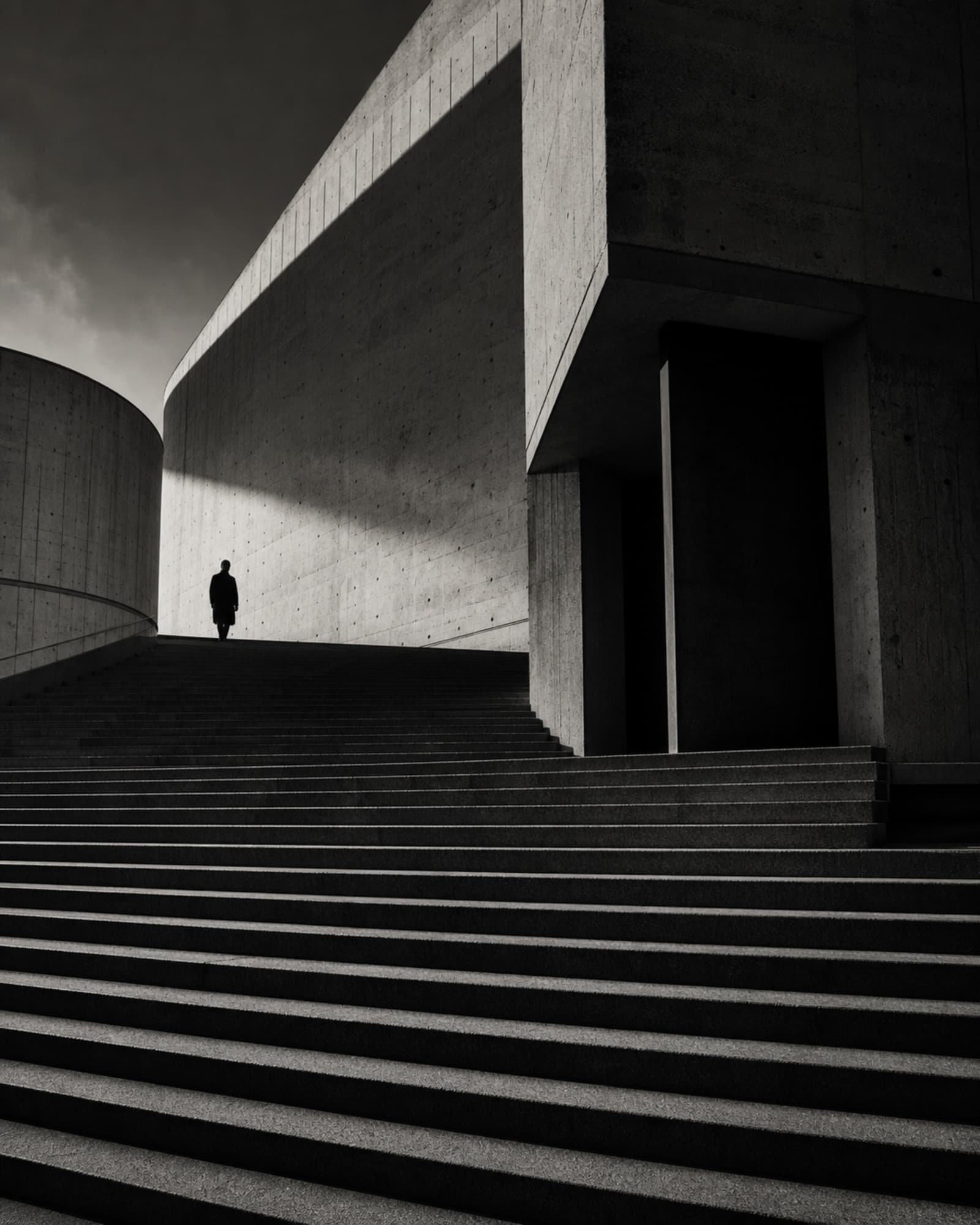 Lone figure on a monumental concrete staircase